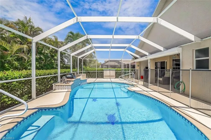 View of swimming pool featuring a patio area and a lanai