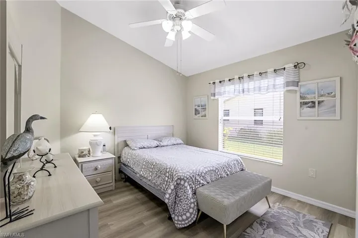 2nd Bedroom featuring ceiling fan, wood-style LVP flooring, and lofted ceiling