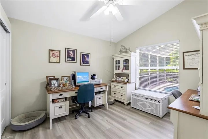 3rd bedroom is used as an office featuring ceiling fan, light wood-type LVP flooring, and lofted ceiling