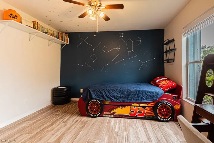 Bedroom featuring hardwood / wood-style flooring and ceiling fan