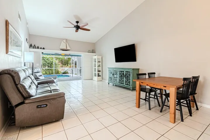 Tiled dining room with high vaulted ceiling