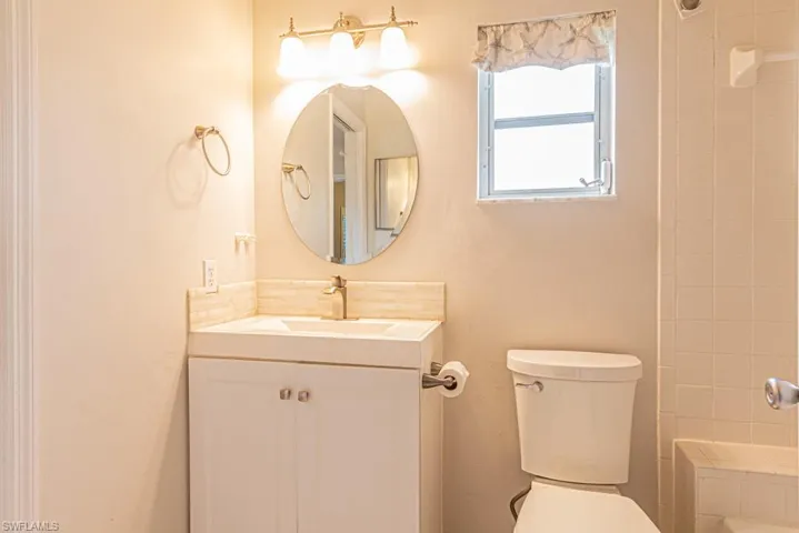Full bathroom featuring vanity, toilet, and shower / tub combo with curtain