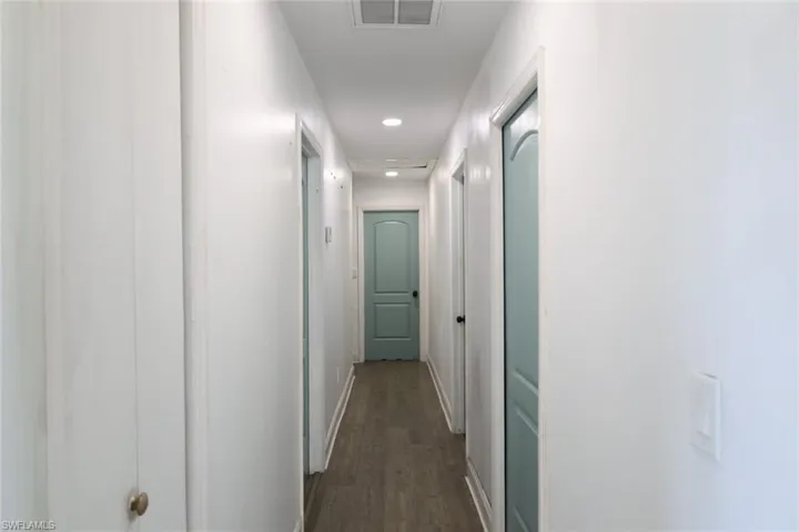 Corridor featuring recessed lighting and dark wood-type flooring
