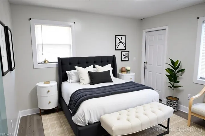 Bedroom with light wood-type flooring and multiple windows