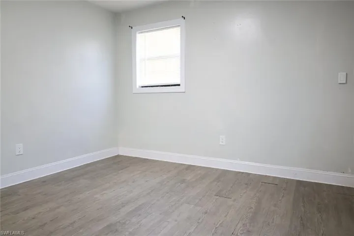 Empty room featuring wood finished floors