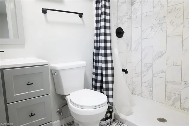 Bathroom featuring vanity and a stall shower