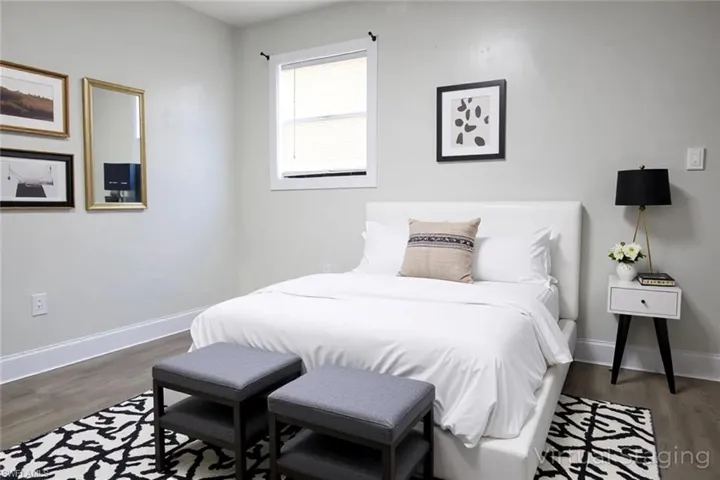 Bedroom featuring wood finished floors and baseboards