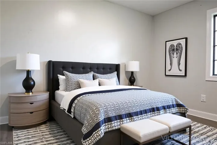 Bedroom featuring wood finished floors and baseboards
