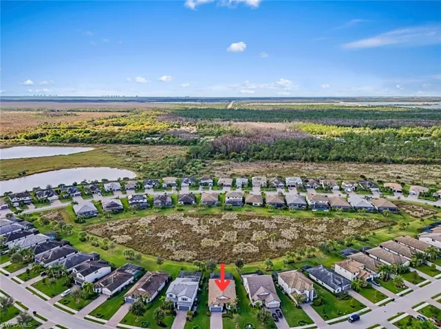 Aerial overview of property's location featuring nearby suburban area and a large body of water