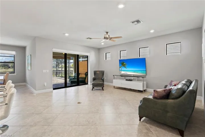 Living area featuring recessed lighting, a ceiling fan, and light tile patterned floors