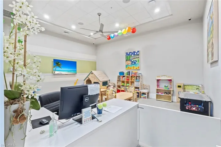 Office space featuring ceiling fan, a drop ceiling, and recessed lighting