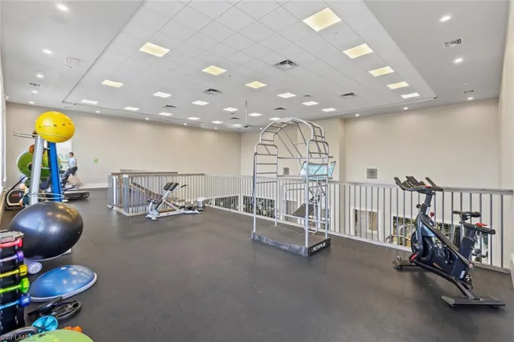 Workout area with a paneled ceiling and recessed lighting