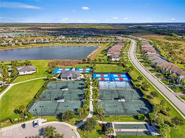 Aerial perspective of suburban area featuring a nearby body of water