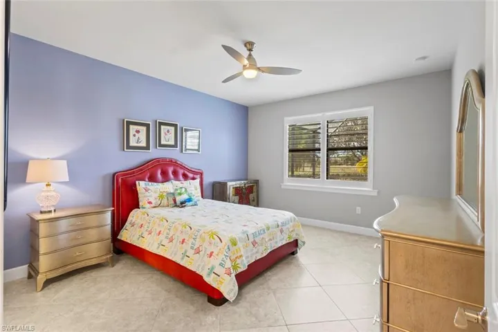 Bedroom featuring a ceiling fan and light tile patterned flooring