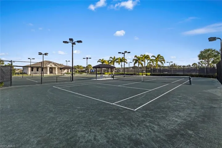 View of tennis court with community basketball court