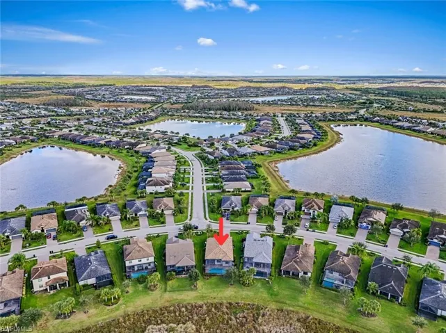 Aerial overview of property's location with nearby suburban area and a large body of water