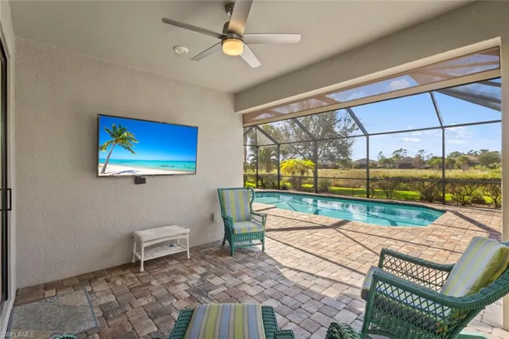 Outdoor pool featuring a patio area, a lanai, and a sunroom