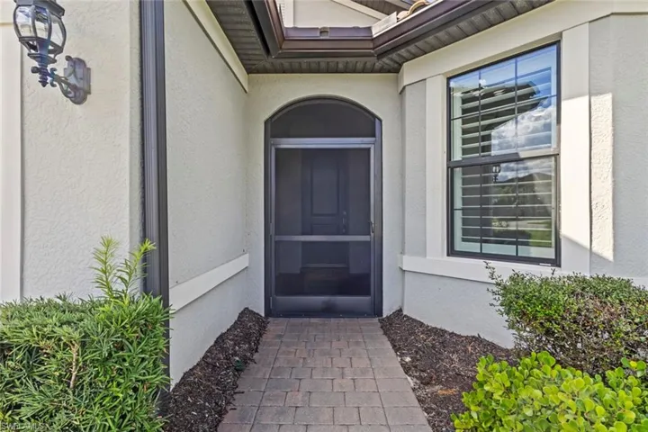 Entrance to property featuring stucco siding