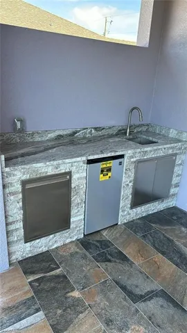 View of patio / terrace featuring exterior kitchen and sink