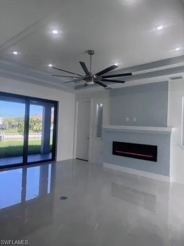 Unfurnished living room featuring a fireplace, recessed lighting, and a ceiling fan
