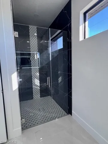 Bathroom with a textured ceiling and an enclosed shower