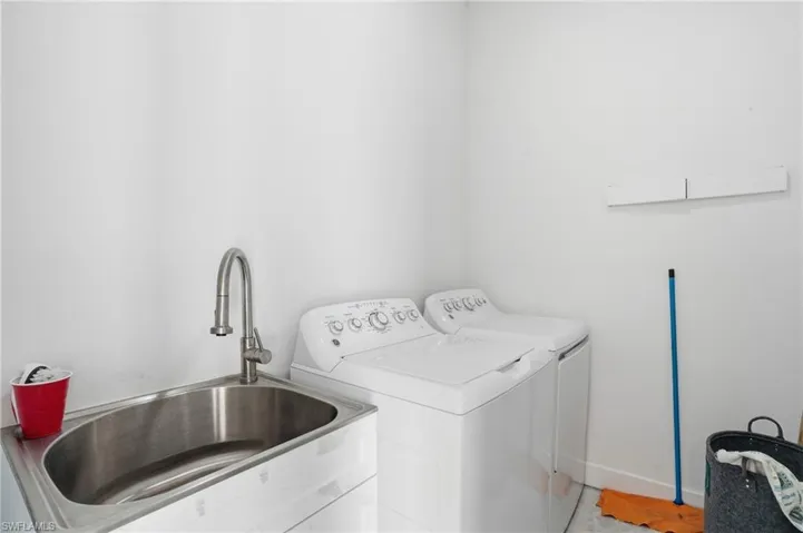 Washroom with washer and clothes dryer