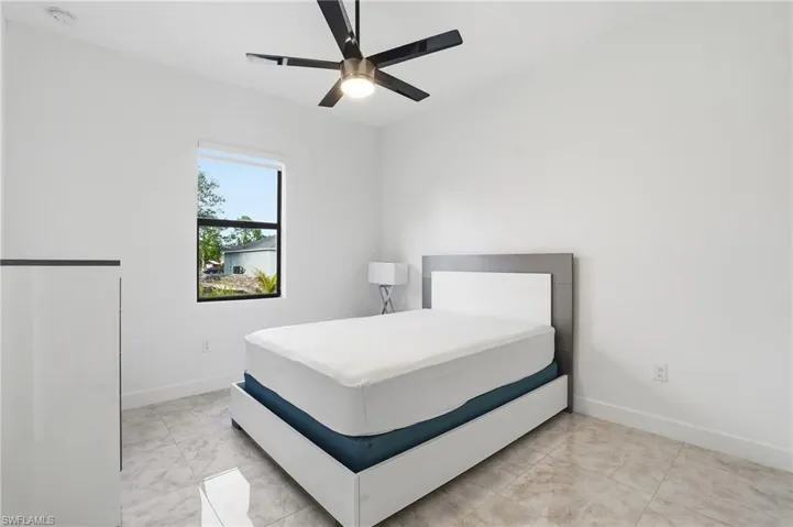 Bedroom with ceiling fan and baseboards