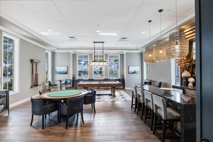 Playroom featuring billiards, crown molding, and dark hardwood / wood-style flooring