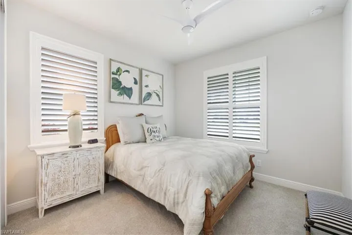 Bedroom featuring ceiling fan and light colored carpet