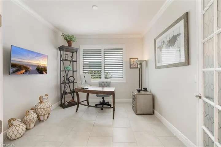 Office featuring light tile patterned flooring and crown molding
