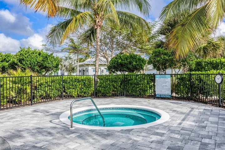View of swimming pool featuring a hot tub