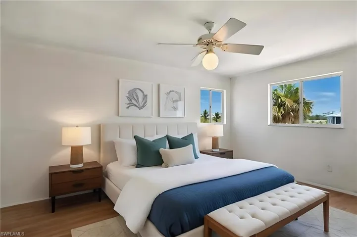 Bedroom 2 with wood finished floors and a ceiling fan - Virtually Staged and Edited Image 2nd floor