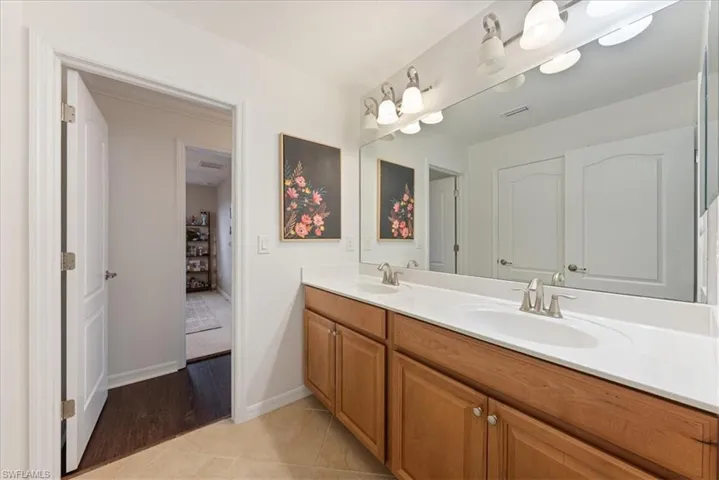Bathroom with double vanity and tile patterned flooring