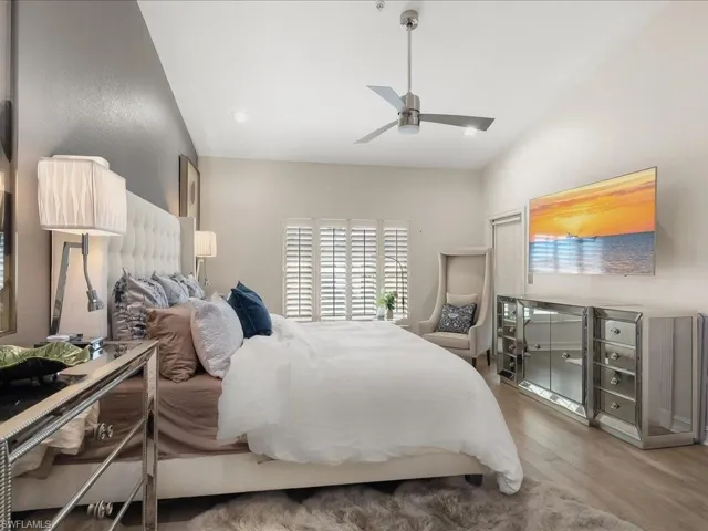 Spacious Master Bedroom featuring wood floors, vaulted ceiling, ensuite bathroom