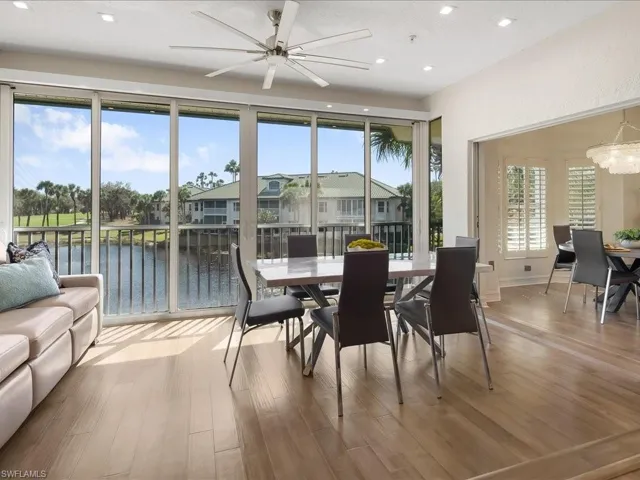 Dining area with lovely golf course and lake views, a modern ceiling fan, light wood floors, and recessed lighting