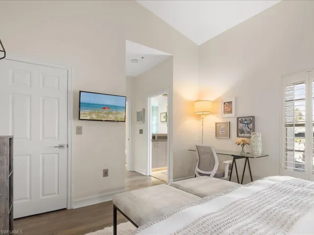 Guest Bedroom #1 featuring wood, high ceilings, plantation shutters and modern ceiling fan