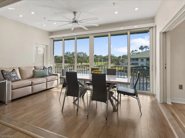 Dining area with lovely golf course and lake views, a modern ceiling fan, light wood floors, and recessed lighting