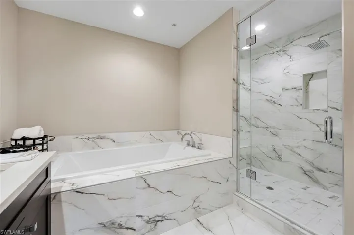 Soaking tub and frameless glass shower create the perfect spa-like retreat right at home!