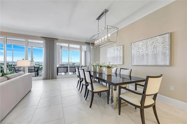Elegant dining space with custom lighting and direct access to the lanai.