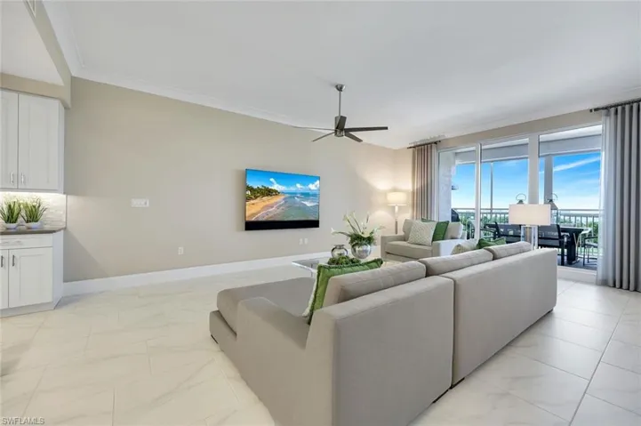Another stunning view of the spacious great room showcasing the open layout, elegant tile flooring, and effortless flow to the outdoor living area!