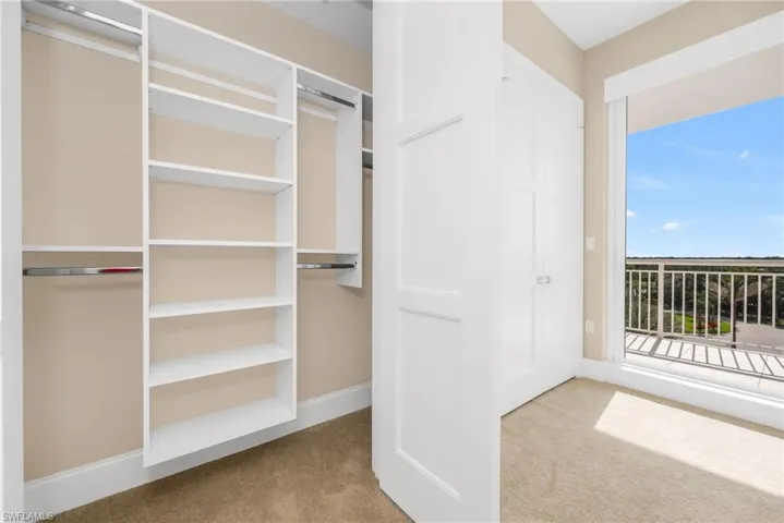 Spacious guest closet with built-in shelving and hanging space for easy everyday organization.