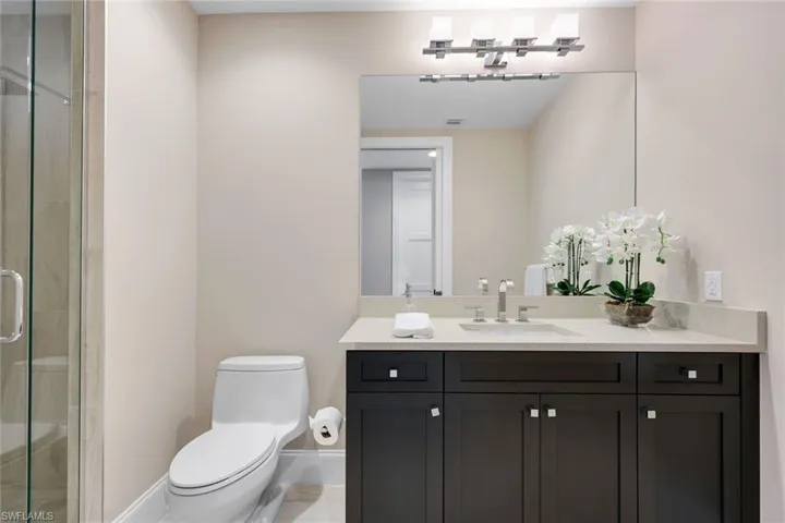 Contemporary guest bath with sleek dark cabinetry, modern lighting, and clean finishes that feel fresh and inviting!