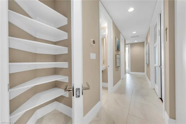 Convenient hallway pantry storage with wraparound shelving — ideal for linens, pantry overflow, or keeping everything neatly tucked away.