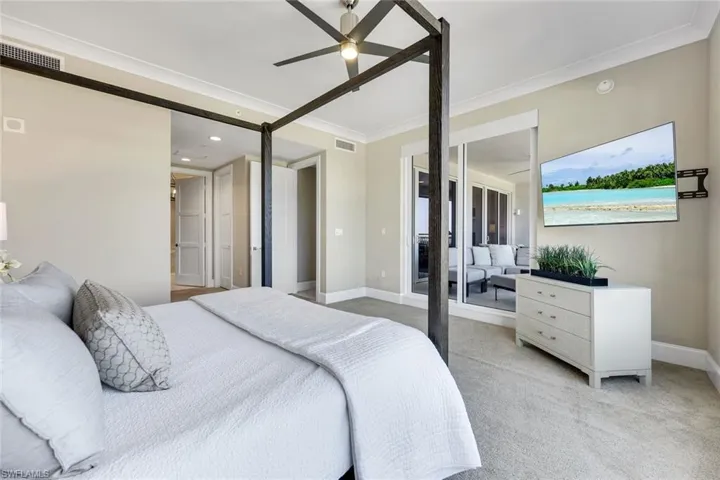 View of the primary suite highlighting the generous layout, peaceful sitting area, and direct access to the ensuite bathroom.