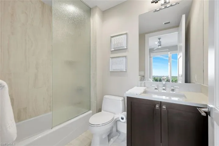 Guest bath offers a tub-and-shower combo with glass enclosure, modern vanity, and a bright, clean design guests will love!
