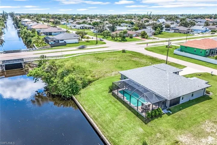 Birds eye view of property with a water view