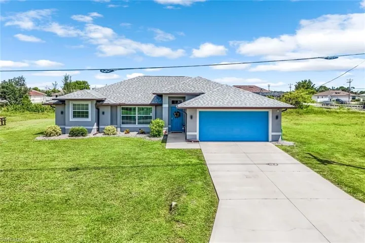 View of front of house featuring a front yard and a garage