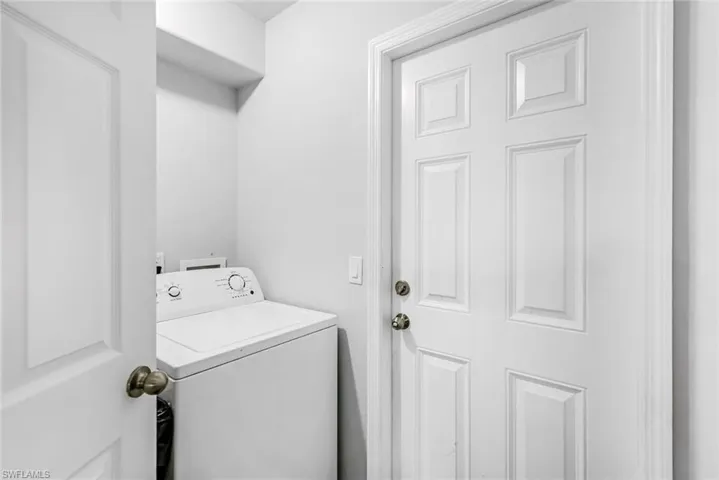 Clothes washing area featuring washer / clothes dryer