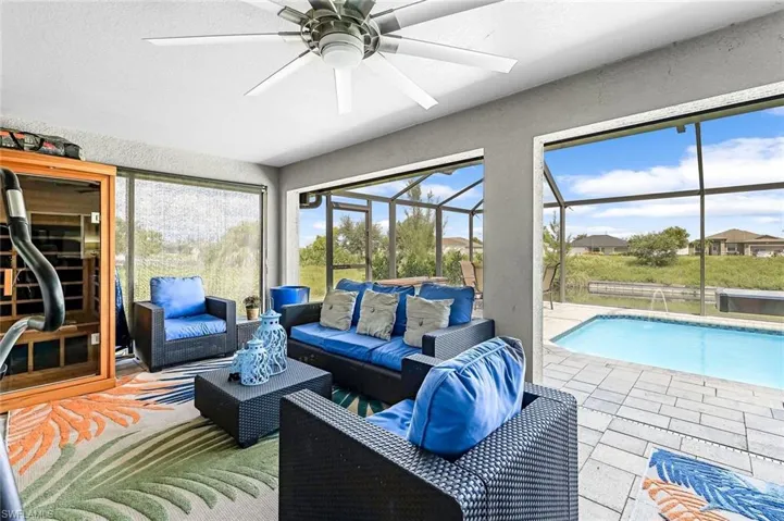 Sunroom featuring ceiling fan