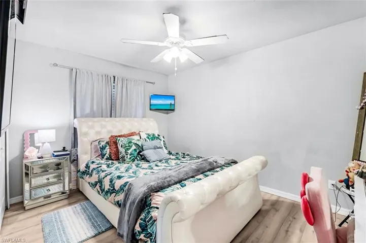Bedroom featuring ceiling fan and light wood-type flooring
